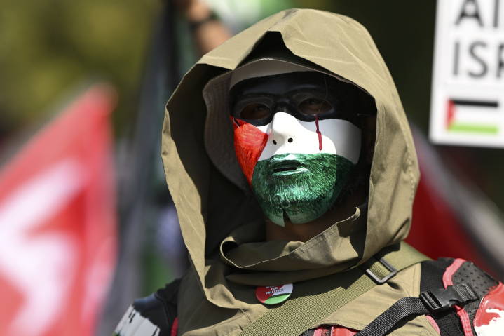 “Pro-Palestinian” protester marches on the Democratic National Convention in Chicago. Team Biden-Harris believes that coercing Israel into a ceasefire would allow Hamas to survive—thus placating far-left, anti-Israel voters and helping achieve victory in the November elections.