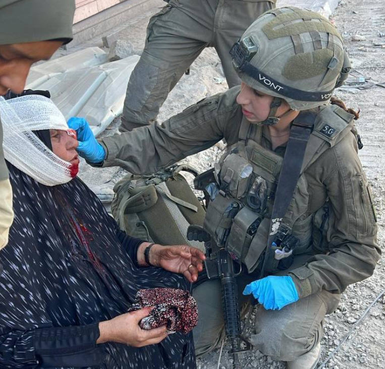 IDF paramedic treats an elderly Palestinian woman injured in Gaza—indicative of Israel’s many extraordinary measures to protect civilian lives at risk due to the human-shield strategy of their Hamas rulers. Despite all such evidence, Amnesty International still accuses Israel of genocide. 